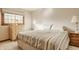 Neutral bedroom featuring a window, striped comforter, wood dresser, and matching nightstands at 757 Howe Dr, Carmel, IN 46032