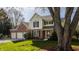 Traditional two-story home with brick and siding, set on a lush green lawn with mature trees, and a spacious two-car garage at 757 Howe Dr, Carmel, IN 46032