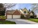Attractive home with a blend of brick and siding, featuring a wide driveway leading to a two-car garage, and a well-kept lawn at 757 Howe Dr, Carmel, IN 46032