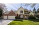 Charming two-story home showcasing a brick and siding exterior, complemented by a well-manicured lawn and a two-car garage at 757 Howe Dr, Carmel, IN 46032