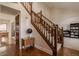 Spacious foyer featuring hardwood floors, a staircase with carpeted steps, and a glimpse into the adjacent dining area at 757 Howe Dr, Carmel, IN 46032