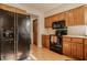Well-lit kitchen boasts updated appliances, natural wood cabinets, and lots of countertop space at 757 Howe Dr, Carmel, IN 46032