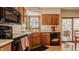 Practical kitchen with wood cabinets, updated appliances, and easy access to the backyard at 757 Howe Dr, Carmel, IN 46032