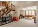 Open living space with a staircase, and furniture, creating a warm and inviting atmosphere for relaxation and entertainment at 757 Howe Dr, Carmel, IN 46032