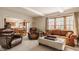 Cozy living room with natural light, comfortable seating, and a view into the eat-in kitchen at 757 Howe Dr, Carmel, IN 46032