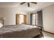Bright bedroom with a ceiling fan, vaulted ceiling, ensuite bathroom, and window views at 757 Howe Dr, Carmel, IN 46032