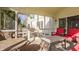 Inviting screened porch with multiple seating areas, perfect for outdoor enjoyment at 757 Howe Dr, Carmel, IN 46032