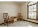 Cozy sitting area with plush seating, neutral carpet, and a large window allowing natural light at 757 Howe Dr, Carmel, IN 46032