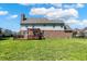 Spacious backyard with lush green grass and a deck with pergola at 7637 Sand Run Ct, Indianapolis, IN 46259