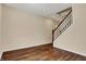 Unfinished basement area with beautiful wood floors and stairs to the upper level at 7637 Sand Run Ct, Indianapolis, IN 46259