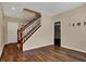 Inviting entryway featuring hardwood floors, staircase, and neutral wall color at 7637 Sand Run Ct, Indianapolis, IN 46259