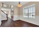 Inviting entryway featuring hardwood floors, staircase with white risers, and a decorative front door at 7637 Sand Run Ct, Indianapolis, IN 46259