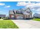 Two-story home featuring brick, attached garage, a long driveway, red shutters and a well manicured lawn at 7637 Sand Run Ct, Indianapolis, IN 46259