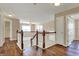 Inviting second-floor hallway featuring hardwood floors, open banister, with views of the living room at 7637 Sand Run Ct, Indianapolis, IN 46259