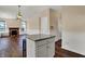 Open-concept kitchen showcases an island with seating, connecting to a living area with a cozy fireplace at 7637 Sand Run Ct, Indianapolis, IN 46259