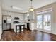 Modern kitchen with white cabinets, stainless steel appliances, and a central island with seating at 7637 Sand Run Ct, Indianapolis, IN 46259