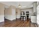 Bright kitchen boasts white cabinetry, stainless steel appliances, island with seating, and access to the backyard at 7637 Sand Run Ct, Indianapolis, IN 46259