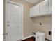 Functional laundry room with cabinetry, a door leading outside, and hookups for a washer and dryer at 7637 Sand Run Ct, Indianapolis, IN 46259