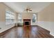 Spacious living room featuring a fireplace, hardwood floors, and large windows that bring in natural light at 7637 Sand Run Ct, Indianapolis, IN 46259