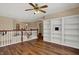 Open loft area with built-in bookshelves, hardwood floors, and great natural light at 7637 Sand Run Ct, Indianapolis, IN 46259