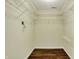 Large walk-in closet with installed shelving and hardwood flooring at 7637 Sand Run Ct, Indianapolis, IN 46259