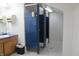 Public restroom featuring multiple stalls, light tile flooring and a wood vanity at 809 S Harrison St, Alexandria, IN 46001