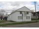 Two-story commercial property with white siding and a dark blue roof, set on a green lawn at 809 S Harrison St, Alexandria, IN 46001