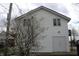 White siding house with a garage and tree blooming in front at 809 S Harrison St, Alexandria, IN 46001