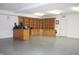 Bright garage space featuring custom built-in shelves, cabinets, and a door to the outside at 809 S Harrison St, Alexandria, IN 46001