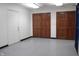 This hallway features tile flooring, bright lighting, and doors leading to various rooms at 809 S Harrison St, Alexandria, IN 46001