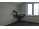 Office with blue carpet and wall and a built-in desk and drawers with window at 809 S Harrison St, Alexandria, IN 46001