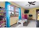 Bright bedroom featuring a window, TV, and colorful decor at 8180 E County Road 400 N, Brownsburg, IN 46112