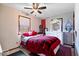 Bedroom featuring a bed with red plaid bedding, white dresser and ceiling fan at 8180 E County Road 400 N, Brownsburg, IN 46112