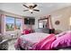 Comfortable bedroom featuring a ceiling fan, large window, and a flat screen TV at 8180 E County Road 400 N, Brownsburg, IN 46112