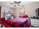 Cozy bedroom featuring a bed with red plaid bedding and a white dresser at 8180 E County Road 400 N, Brownsburg, IN 46112