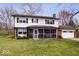 Charming two-story home featuring a well-manicured lawn and an inviting screened-in porch area at 8180 E County Road 400 N, Brownsburg, IN 46112