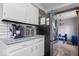 Bright kitchen with white cabinets, stainless appliances, and adjacent living area access at 8180 E County Road 400 N, Brownsburg, IN 46112