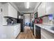 Updated kitchen boasts white cabinets, stainless steel appliances, and tile backsplash at 8180 E County Road 400 N, Brownsburg, IN 46112