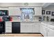 Updated kitchen sink featuring a window and stainless steel appliances with backsplash at 8180 E County Road 400 N, Brownsburg, IN 46112