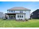 Spacious backyard featuring a lush green lawn and a covered patio area at 8452 Ironhill Ct, Indianapolis, IN 46259