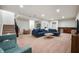Large basement with plush carpet, a blue sectional sofa, kitchenette, and space for recreation and play at 8452 Ironhill Ct, Indianapolis, IN 46259