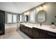 Elegant bathroom featuring double sinks, quartz countertops, and a luxurious soaking tub at 8452 Ironhill Ct, Indianapolis, IN 46259