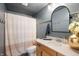Cozy bathroom featuring a decorative mirror, shower curtain, and beadboard wall accents at 8452 Ironhill Ct, Indianapolis, IN 46259