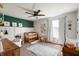 Bright Bedroom with white armchair, wooden crib, ceiling fan, and large windows with plenty of light at 8452 Ironhill Ct, Indianapolis, IN 46259