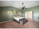 Stylish bedroom with a tray ceiling, modern ceiling fan, and beautiful wall art at 8452 Ironhill Ct, Indianapolis, IN 46259