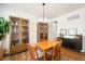 Cozy dining room with wooden table, chairs, and cabinetry, featuring a stylish chandelier and ample natural light at 8452 Ironhill Ct, Indianapolis, IN 46259