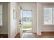 Bright foyer with an open door, showcasing a view of the neighborhood, and hardwood floors with natural light at 8452 Ironhill Ct, Indianapolis, IN 46259