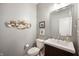 Stylish half bathroom with gray walls, decorative accents, and a dark wood vanity with a white sink at 8452 Ironhill Ct, Indianapolis, IN 46259