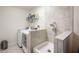 Functional laundry room with modern appliances and a tiled dog wash area at 8452 Ironhill Ct, Indianapolis, IN 46259