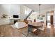 Inviting living room with a stone fireplace, staircase, hardwood floors, and an open dining area filled with natural light at 8452 Ironhill Ct, Indianapolis, IN 46259